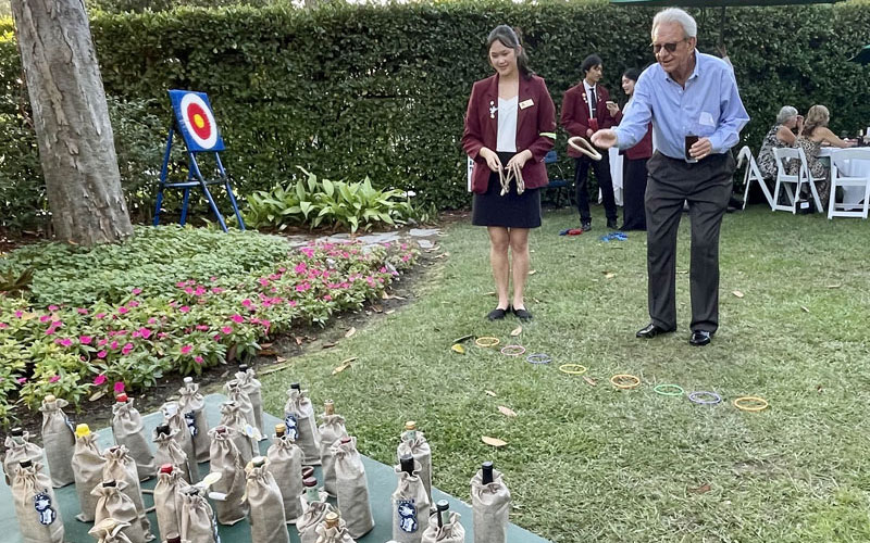 party guest plays wine ring toss at the 2024 CAS Garden Party