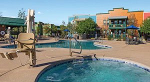 photo of pool, jacuzzi, and building