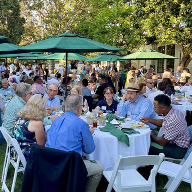 A large number of guests enjoying food and drink