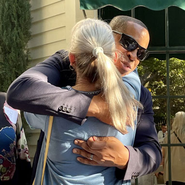 Friends greeting each other with a hug