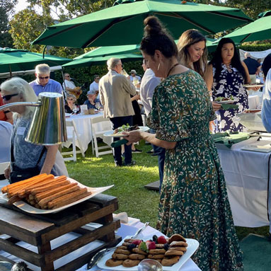 Guests choosing from a selection of desserts.